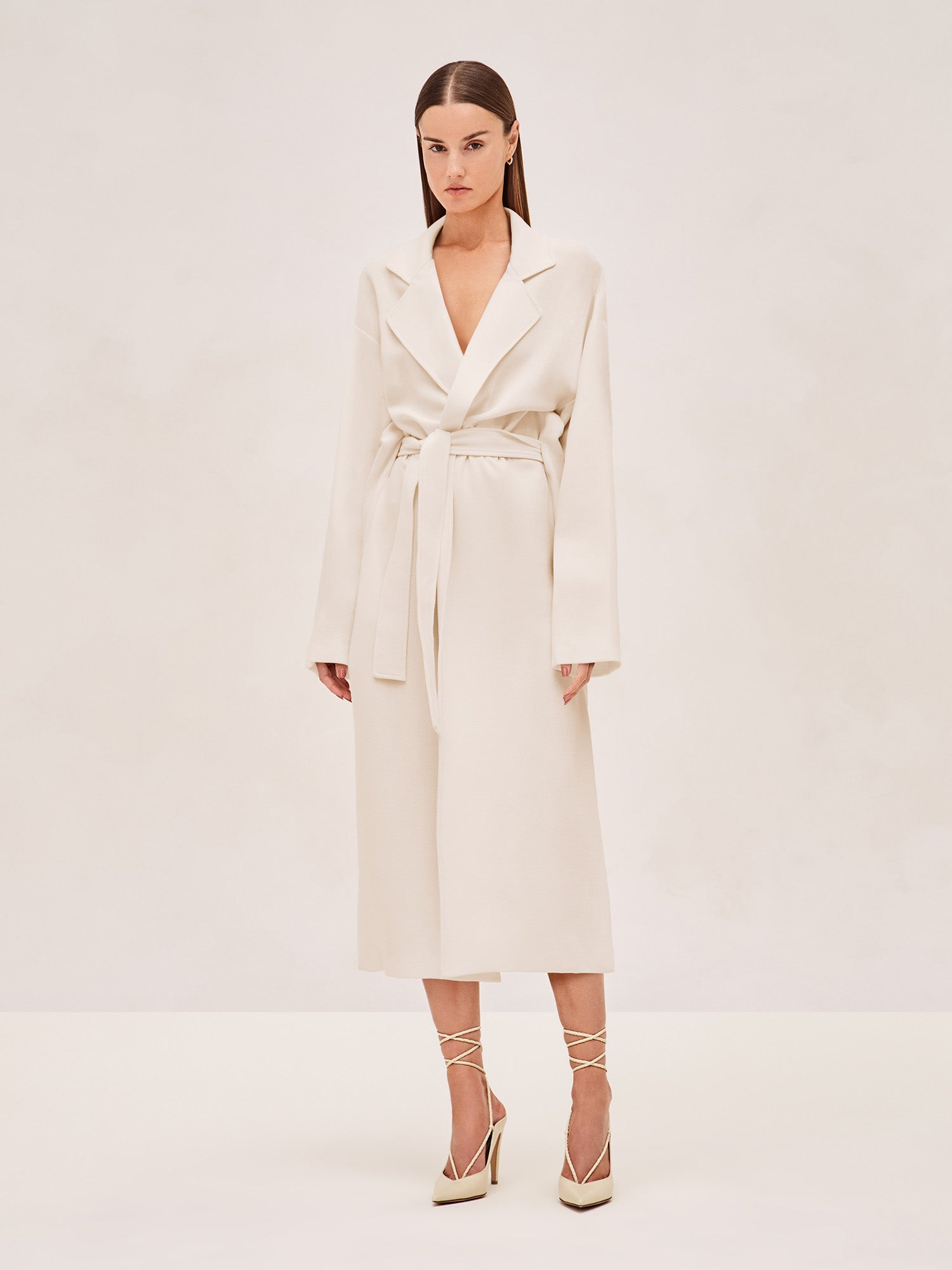 ALEXIS EAST MIDI COAT IN IVORY WITH SASH BELT.