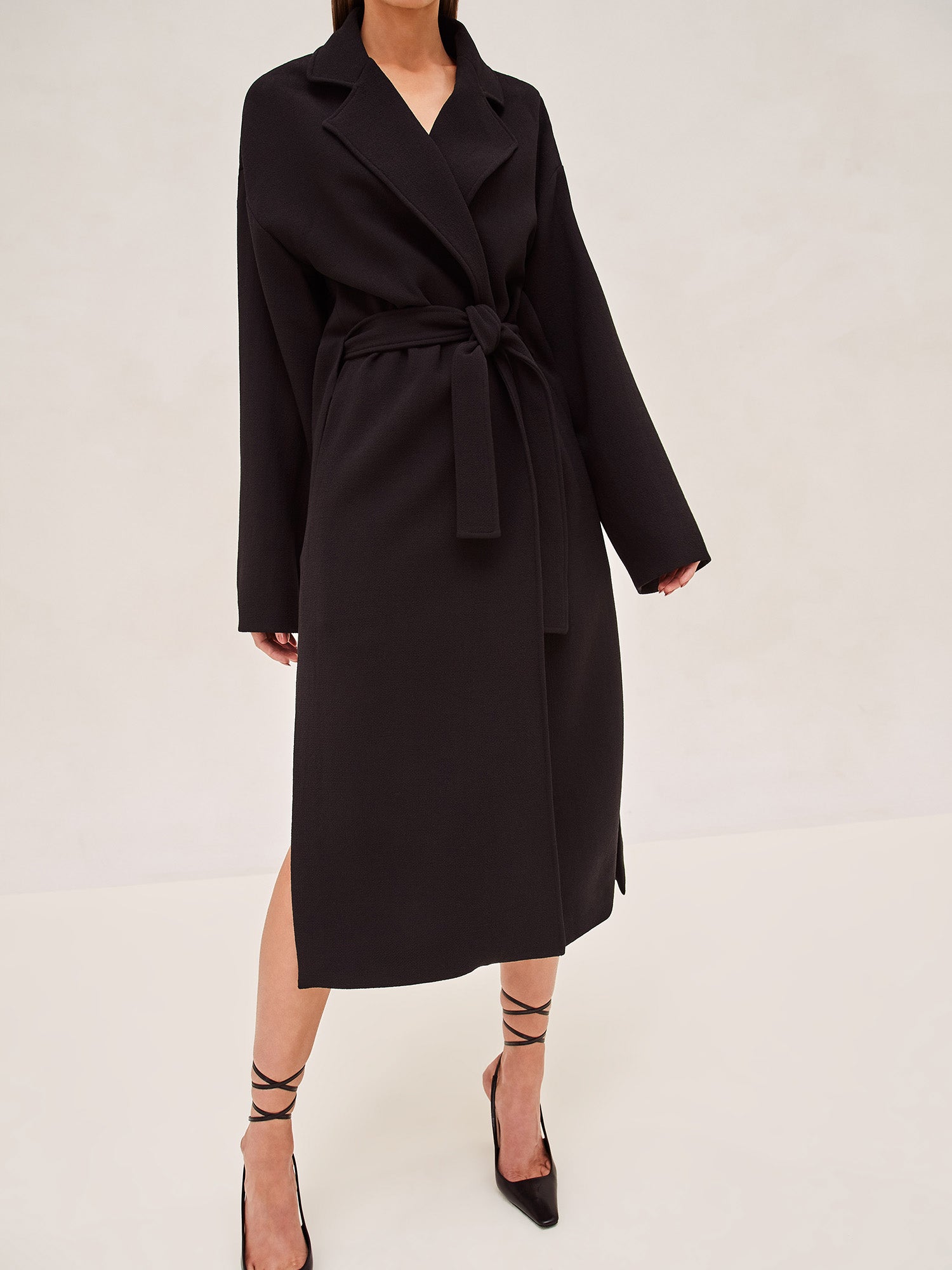 ALEXIS EAST MIDI COAT IN BLACK WITH SASH BELT.