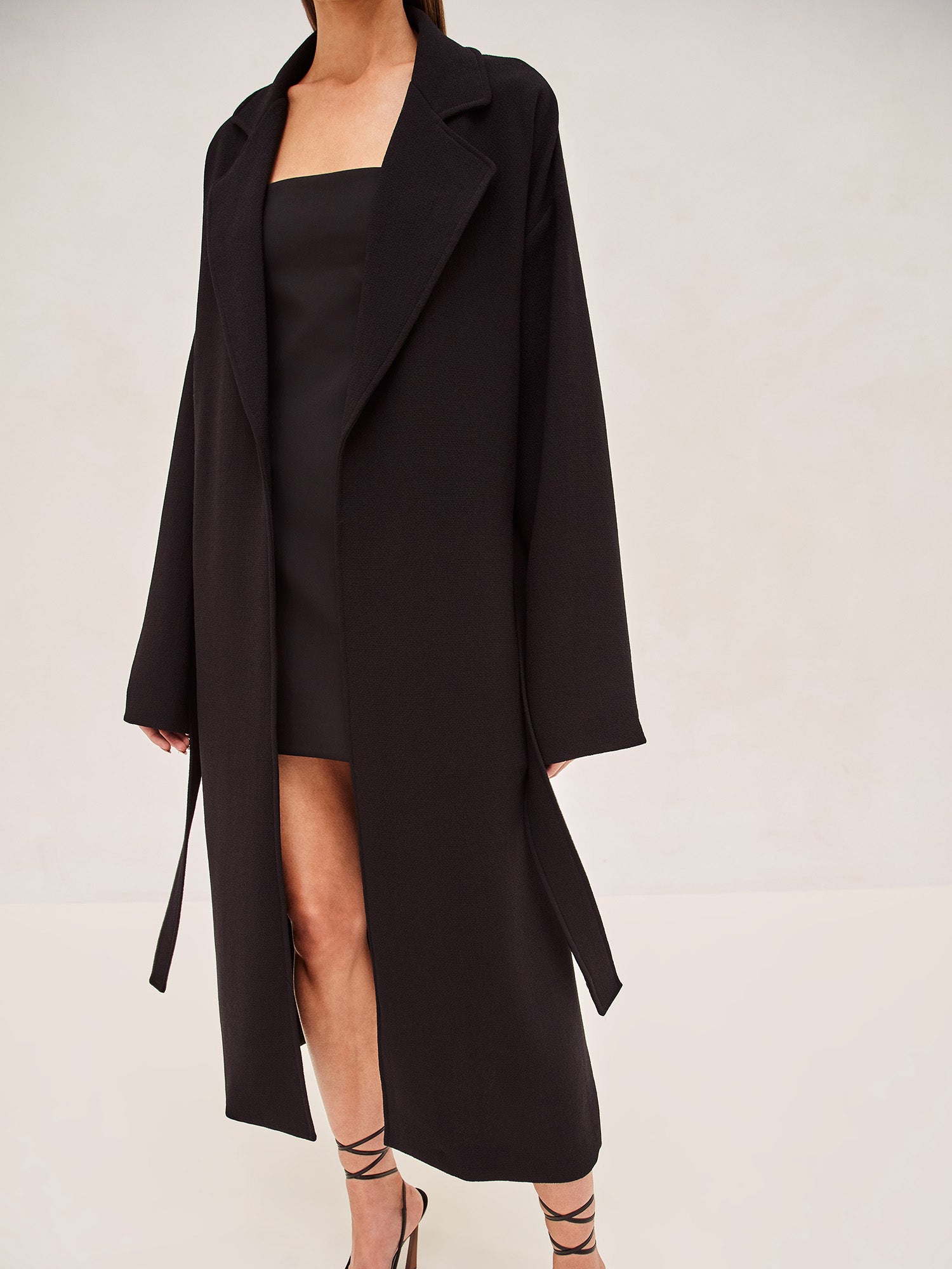 ALEXIS EAST MIDI COAT IN BLACK WITH SASH BELT.