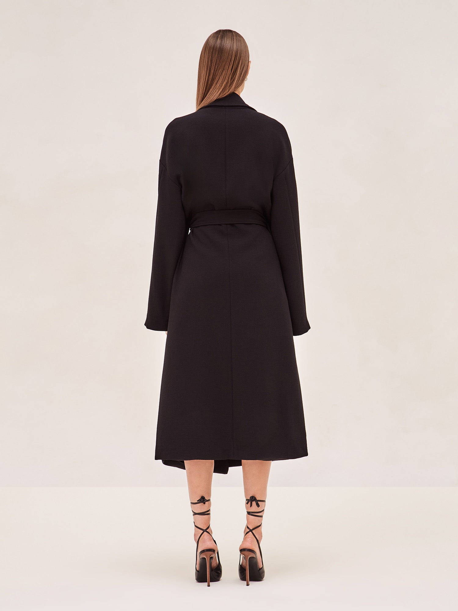 ALEXIS EAST MIDI COAT IN BLACK WITH SASH BELT.