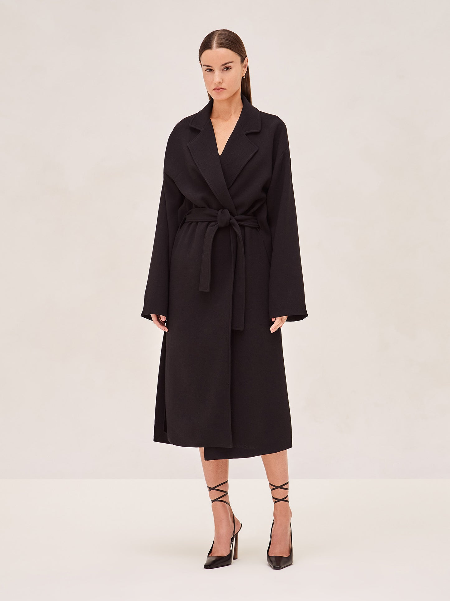 ALEXIS EAST MIDI COAT IN BLACK WITH SASH BELT.