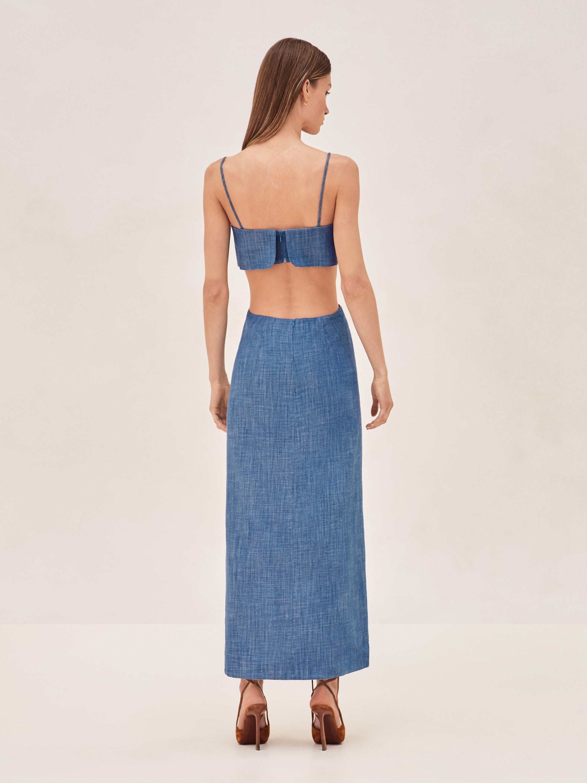 ALEXIS Denim sleevless maxi dress with side cut outs and slits up the front.