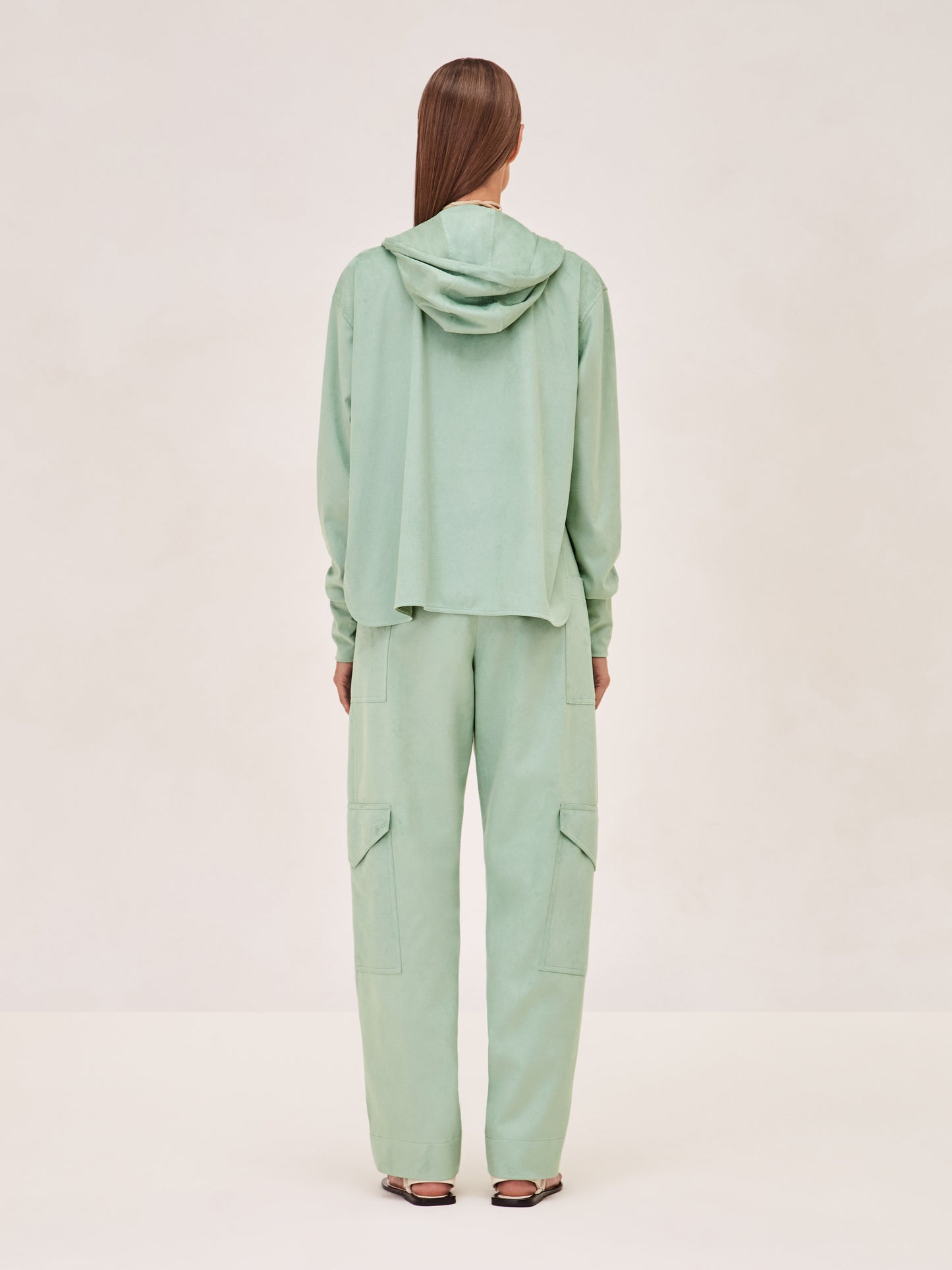 ALEXIS Suda top in sage with zipper and hood. 